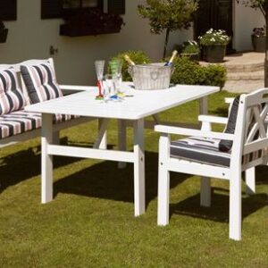 White table and benches with sea cushions on the lawn - summer set Wood Luxury.